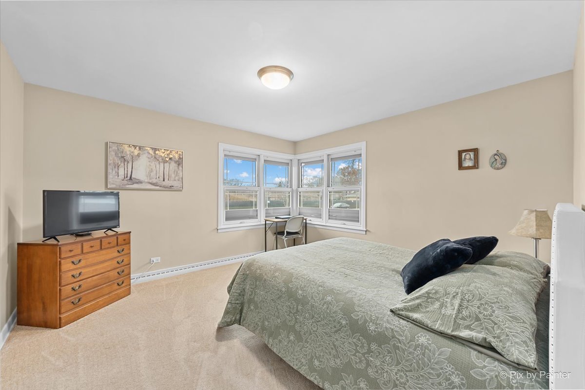 431 North Melrose Avenue Elgin, IL 60123 - Photo 5 of 32 a bedroom with a bed and flat screen tv