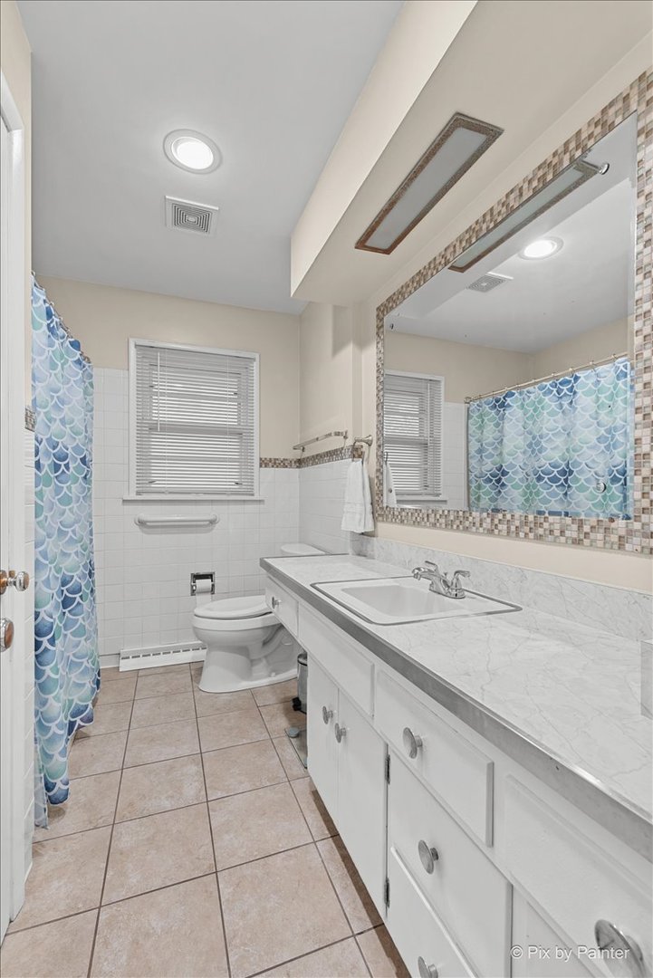 431 North Melrose Avenue Elgin, IL 60123 - Photo 7 of 32 a bathroom with a sink a toilet and mirror