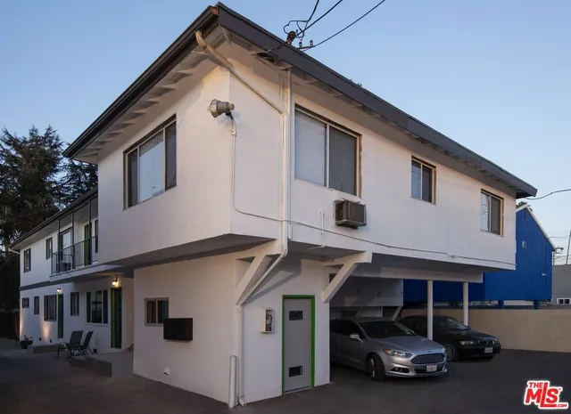 a view of a white house with many windows