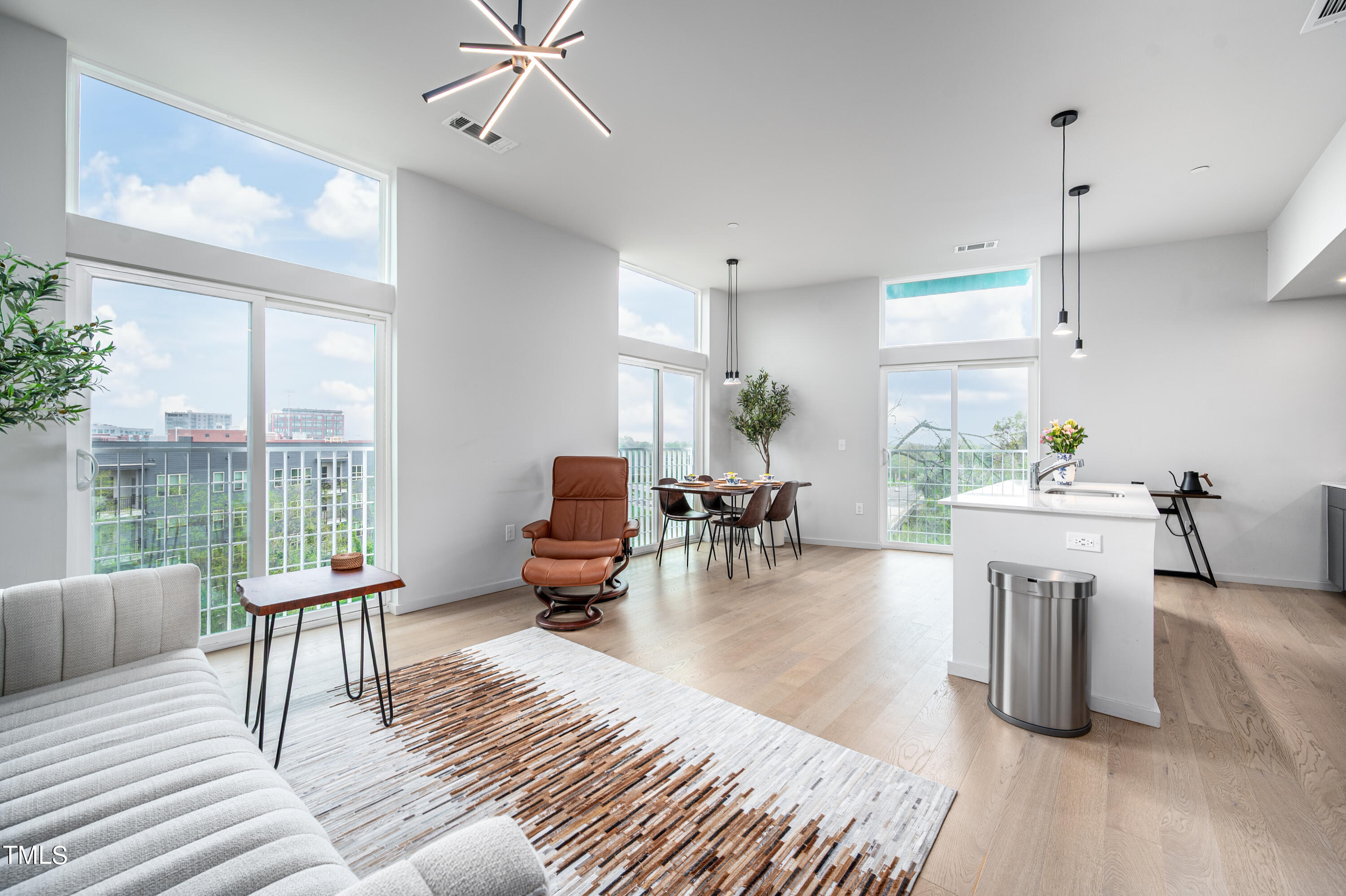 a living room with furniture a fireplace and a table