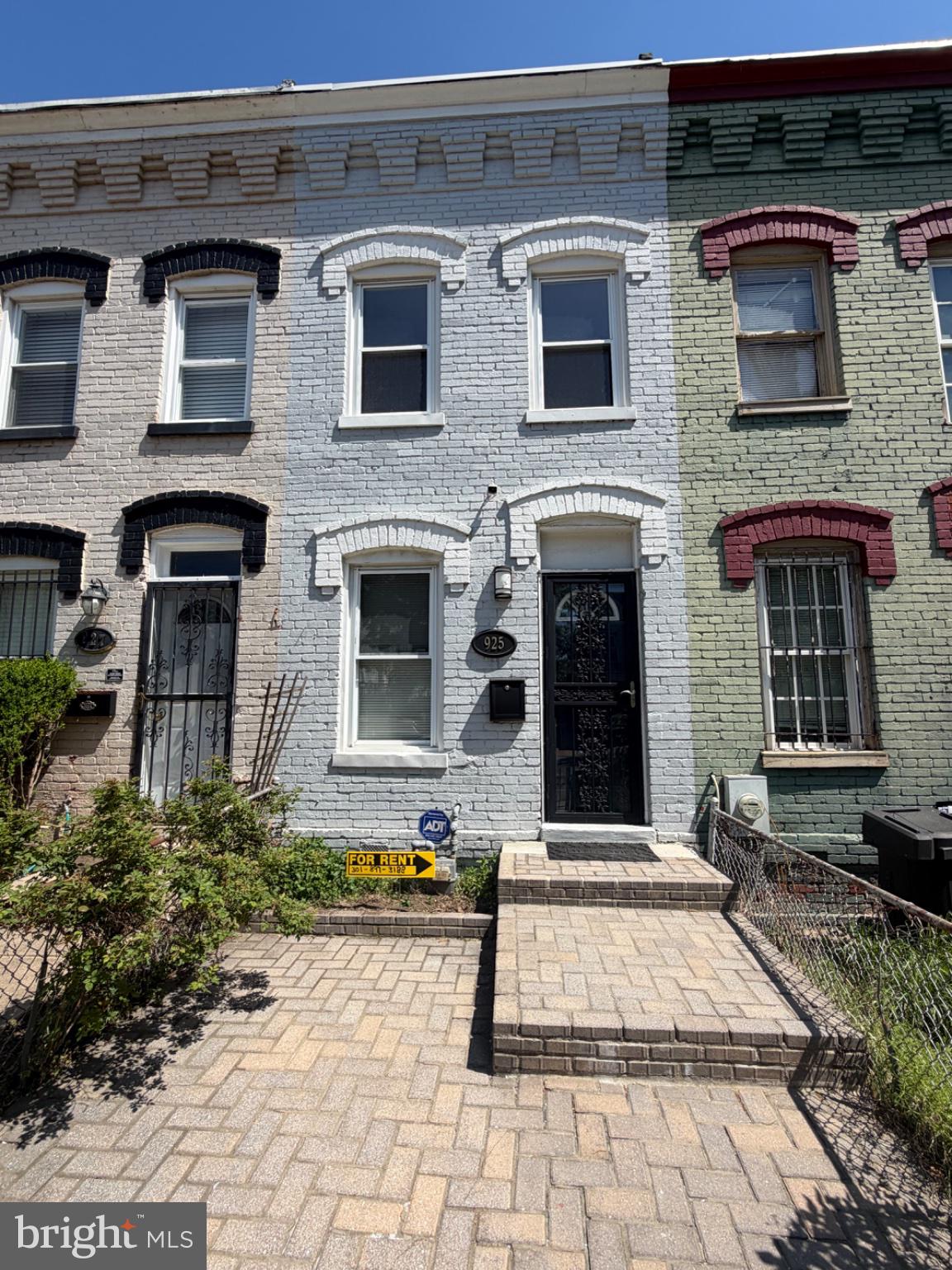 Charming row home with vibrant hues.