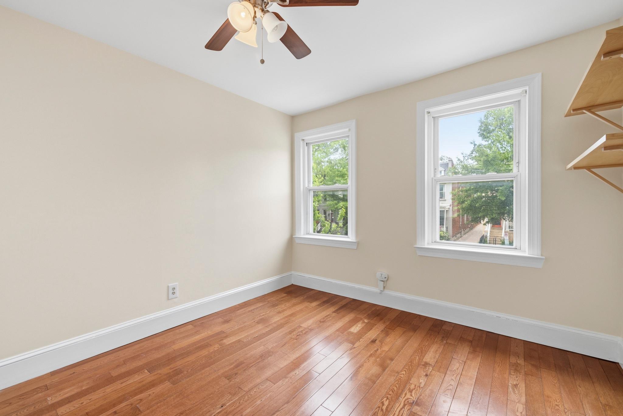 925 8th Street Northeast Washington, DC 20002 - Photo 17 of 24 a view of an empty room with wooden floor and a window