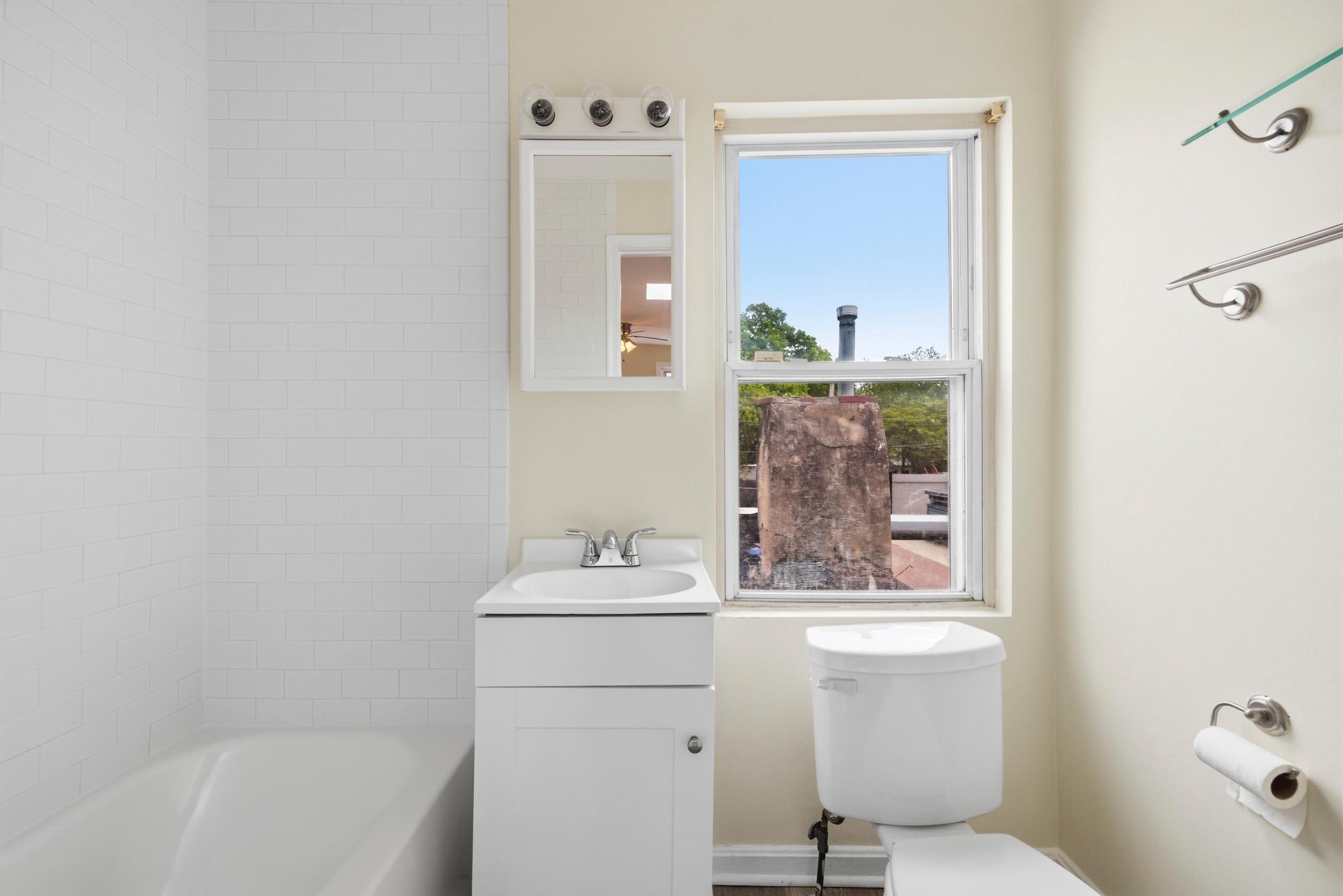 925 8th Street Northeast Washington, DC 20002 - Photo 21 of 24 a bathroom with a sink toilet and mirror