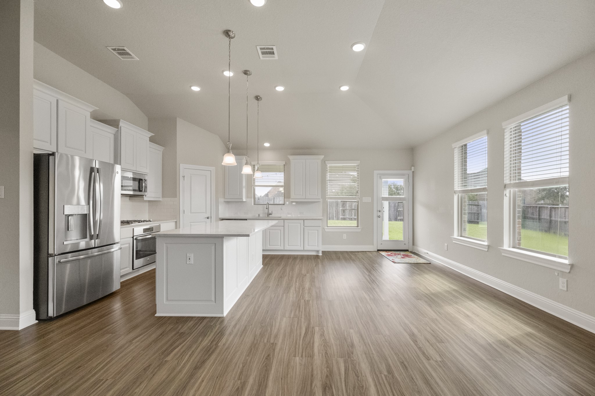 7502 Windsor Park Court Spring, TX 77379 - Photo 10 of 50 a kitchen with stainless steel appliances granite countertop a refrigerator a sink dishwasher a stove and white countertops with wooden floor