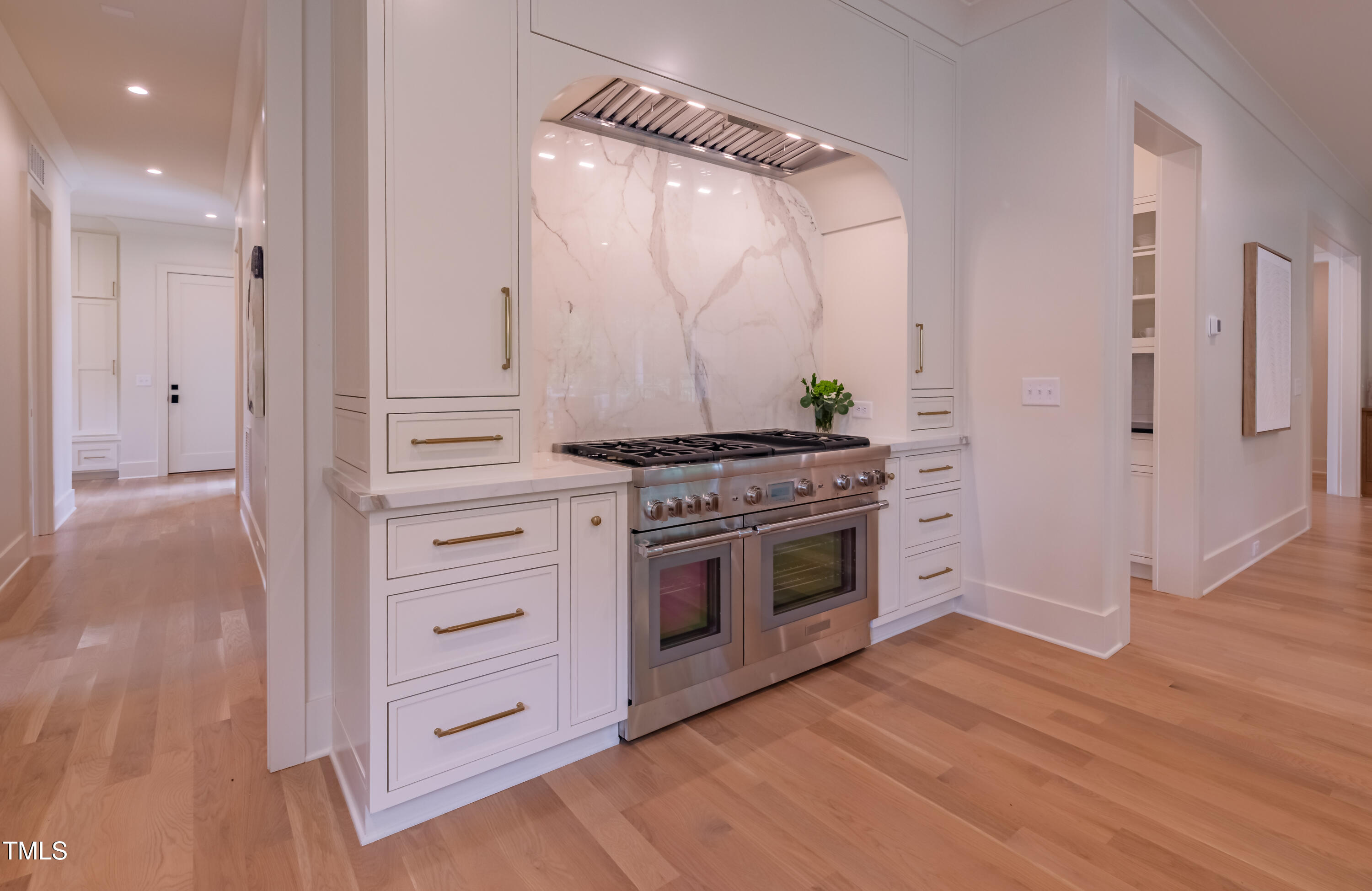 2227 Wheeler Road Raleigh, NC 27607 - Photo 23 of 56 a kitchen with stainless steel appliances a stove and a wooden floor
