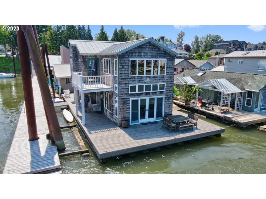 111 North Bridgeton Road, Unit E05 Portland, OR 97217 - Photo 1 of 42 a view of a house with pool lawn chairs and couches
