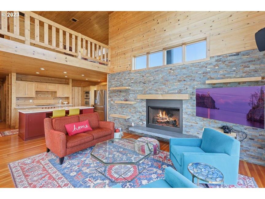 111 North Bridgeton Road, Unit E05 Portland, OR 97217 - Photo 16 of 42 a living room with furniture a fireplace and a table