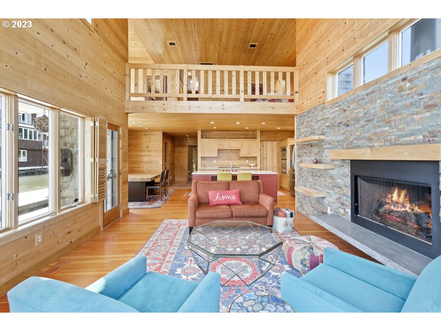 111 North Bridgeton Road, Unit E05 Portland, OR 97217 - Photo 17 of 42 a living room with furniture and a fireplace