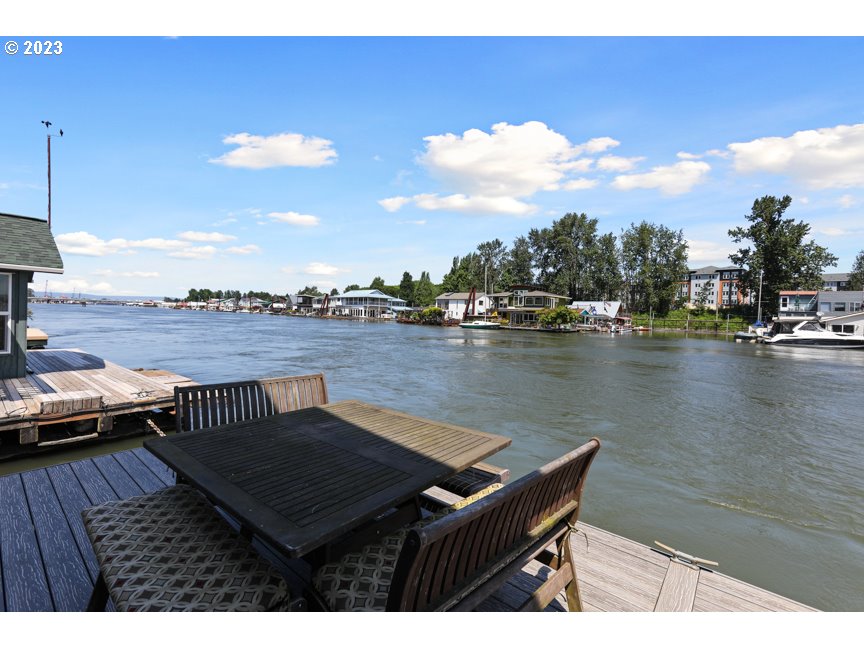 111 North Bridgeton Road, Unit E05 Portland, OR 97217 - Photo 18 of 42 a view of a lake with couches chairs