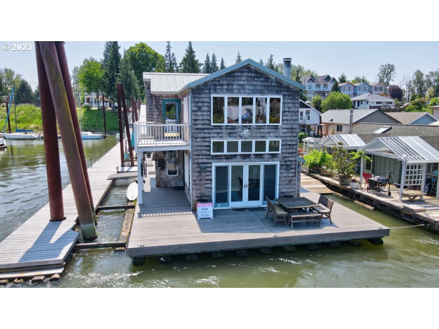 111 North Bridgeton Road, Unit E05 Portland, OR 97217 - Photo 2 of 42 a view of a house with pool yard and sitting area