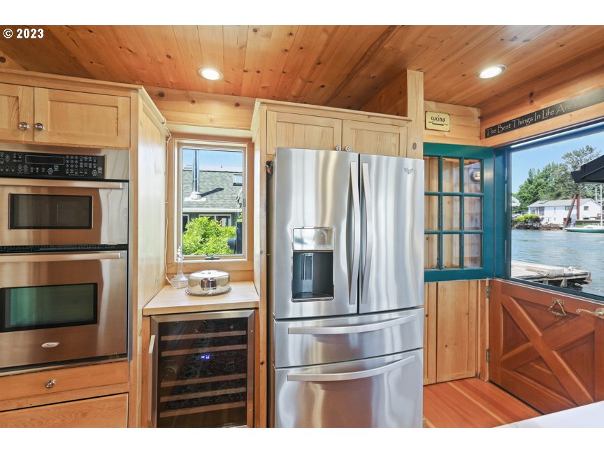 111 North Bridgeton Road, Unit E05 Portland, OR 97217 - Photo 23 of 42 a kitchen with stainless steel appliances a stove and a refrigerator