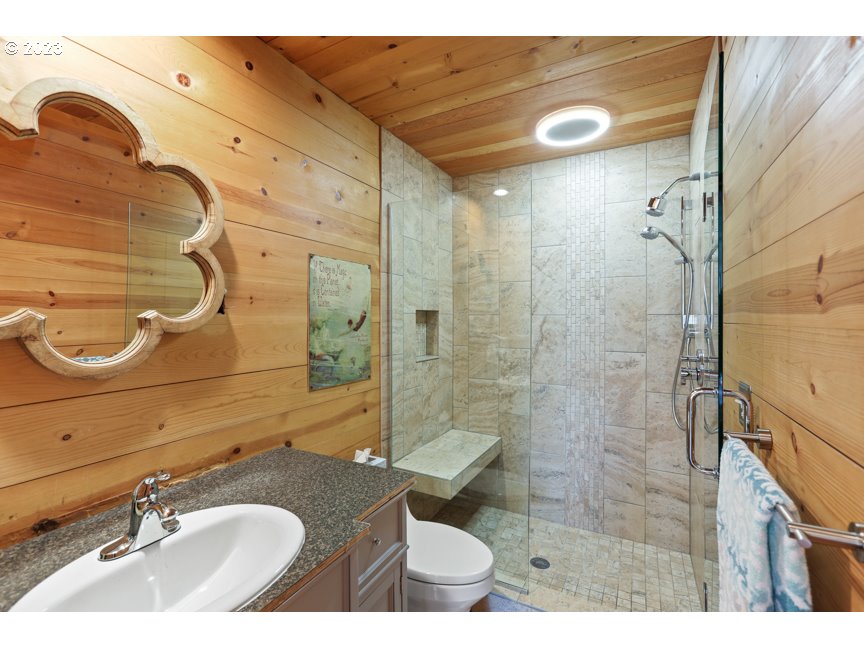 111 North Bridgeton Road, Unit E05 Portland, OR 97217 - Photo 27 of 42 a bathroom with a granite countertop sink toilet and shower