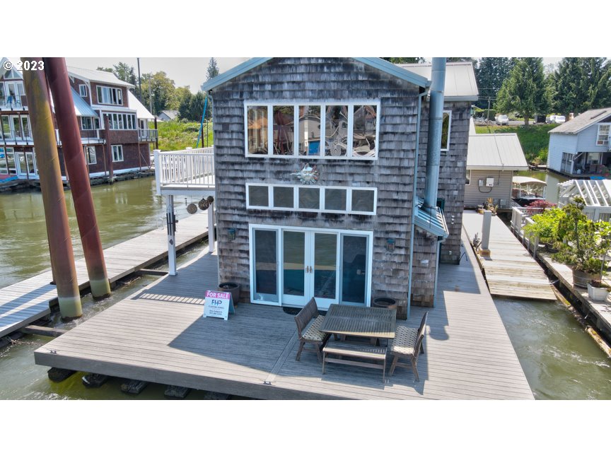 111 North Bridgeton Road, Unit E05 Portland, OR 97217 - Photo 3 of 42 a backyard of a house with barbeque oven table and chairs