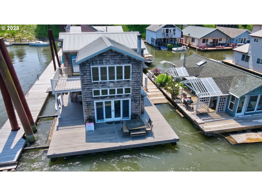 111 North Bridgeton Road, Unit E05 Portland, OR 97217 - Photo 8 of 42 a aerial view of a house with swimming pool and lake view
