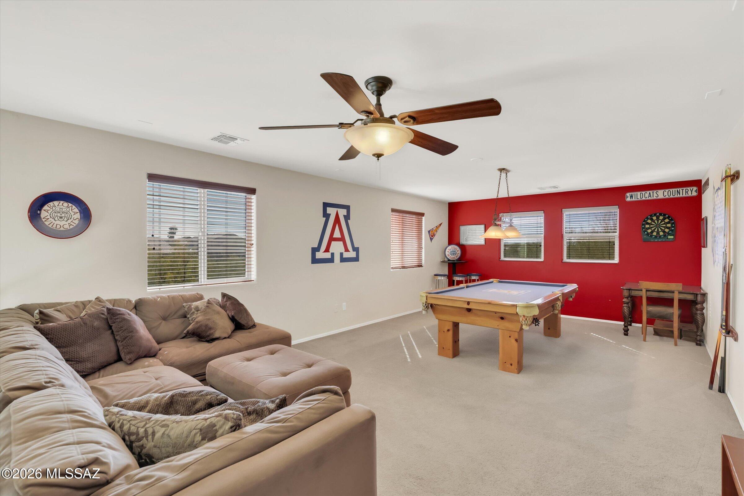 6095 South Jakemp Trail Tucson, AZ 85747 - Photo 23 of 52 a living room with furniture a table and a window