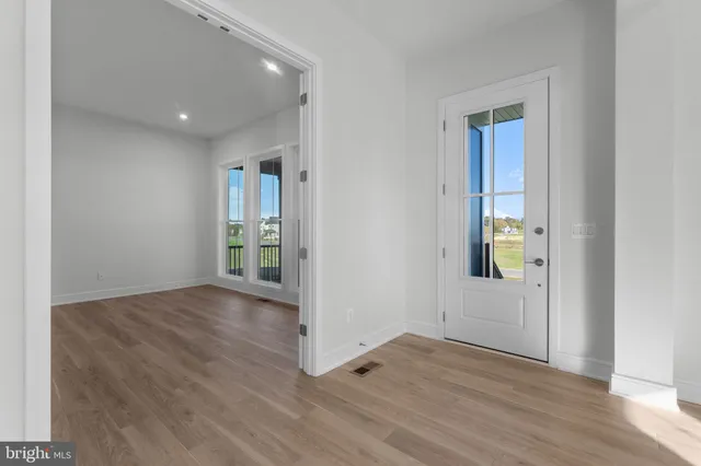 a view of a hallway view with wooden floor and staircase