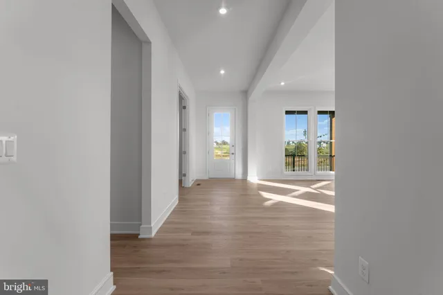 a view of an entryway with wooden floor