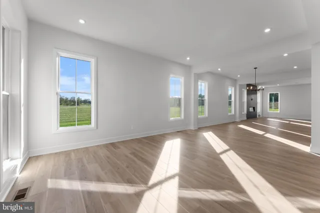 a large kitchen with kitchen island granite countertop a large counter top stainless steel appliances and cabinets