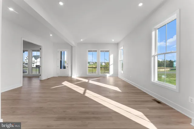 a large kitchen with stainless steel appliances kitchen island granite countertop a stove a sink a refrigerator and a granite counter tops