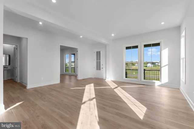 a large kitchen with stainless steel appliances kitchen island granite countertop a refrigerator a sink and a stove