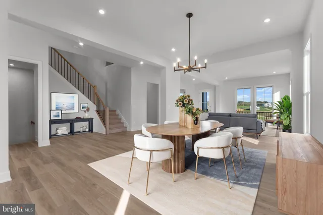 a large kitchen with kitchen island granite countertop a sink a counter top space and cabinets