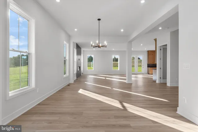 a kitchen with stainless steel appliances granite countertop a sink a stove and a refrigerator