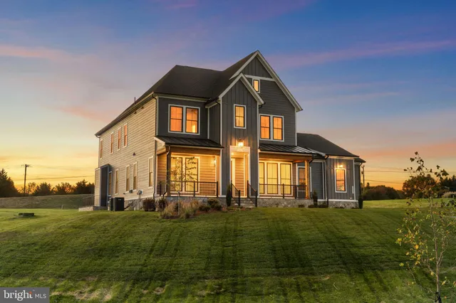 a front view of a house with a big yard