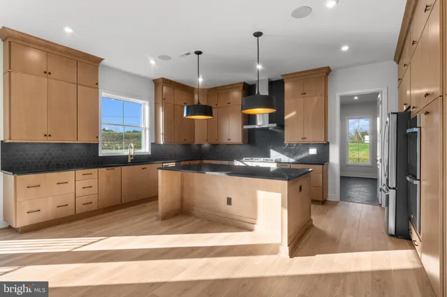 a view of a hallway with wooden floor and windows