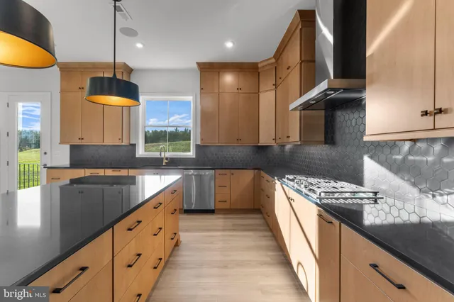 a bathroom with a granite countertop sink toilet a large mirror a bathtub and shower