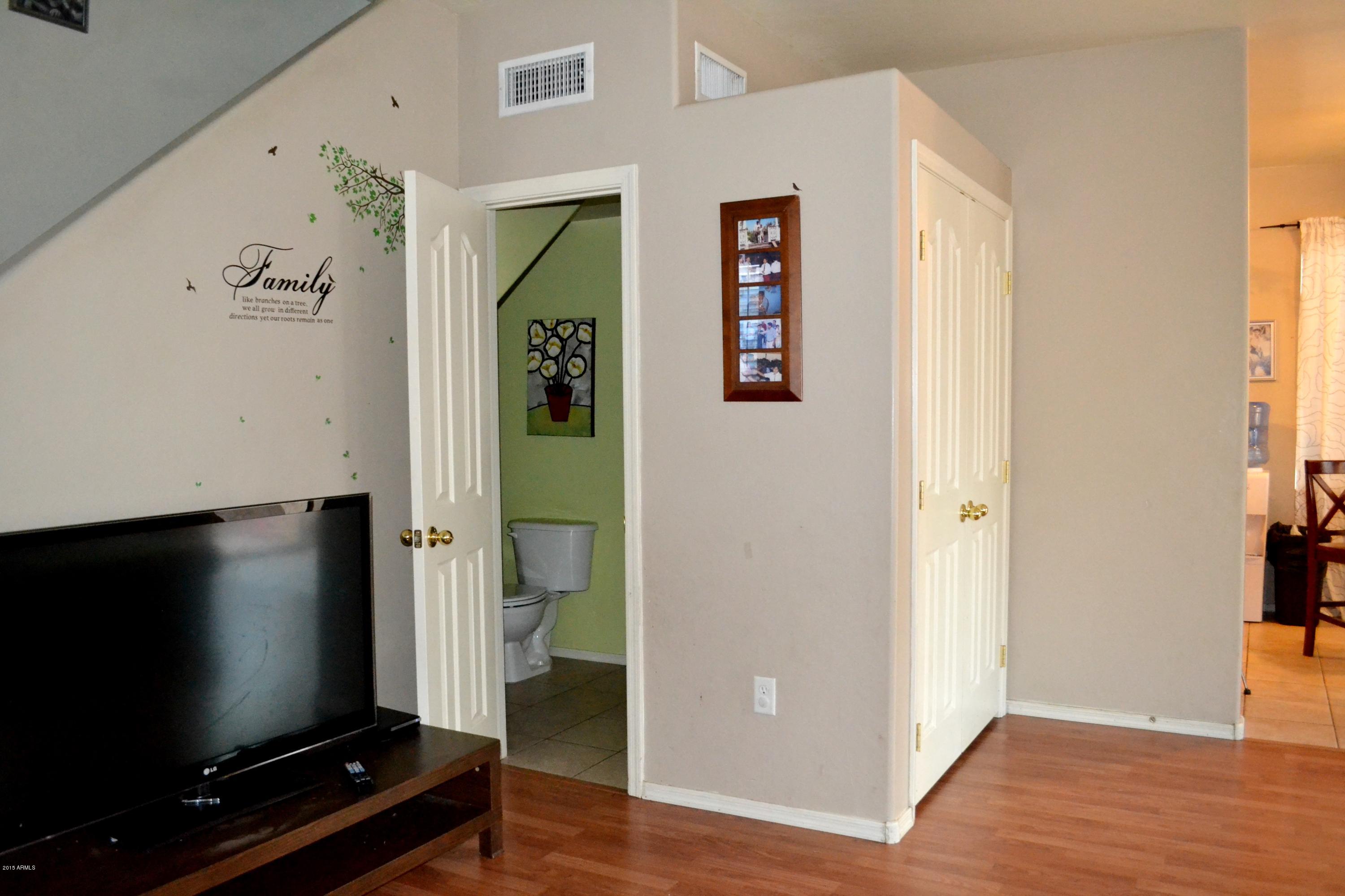 3906 West Carter Road Phoenix, AZ 85041 - Photo 13 of 32 a living room with a flat screen tv and a window