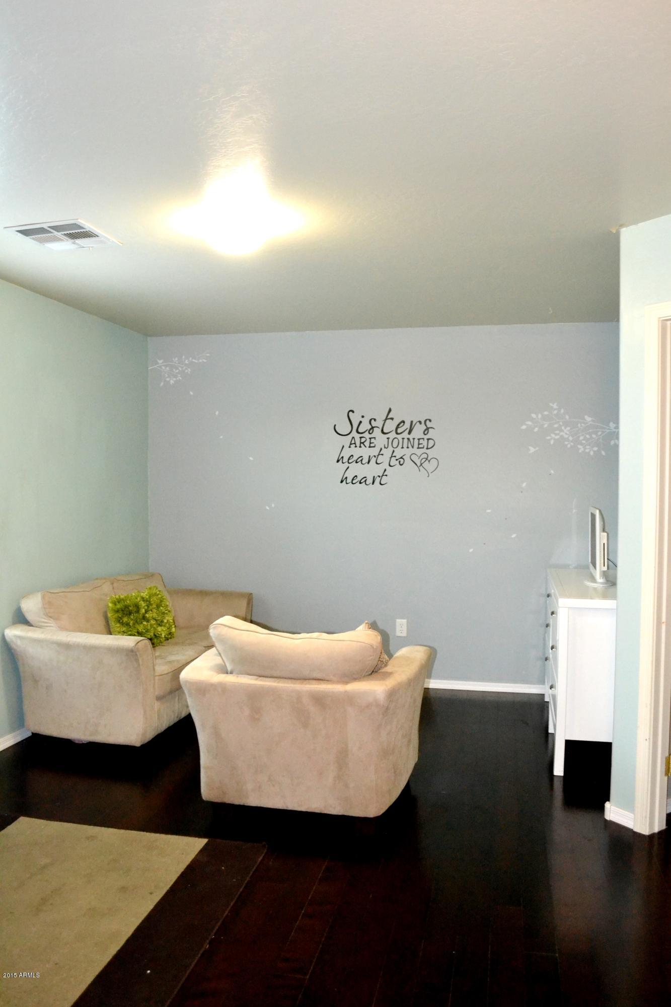 3906 West Carter Road Phoenix, AZ 85041 - Photo 16 of 32 a living room with a couch and a potted plant
