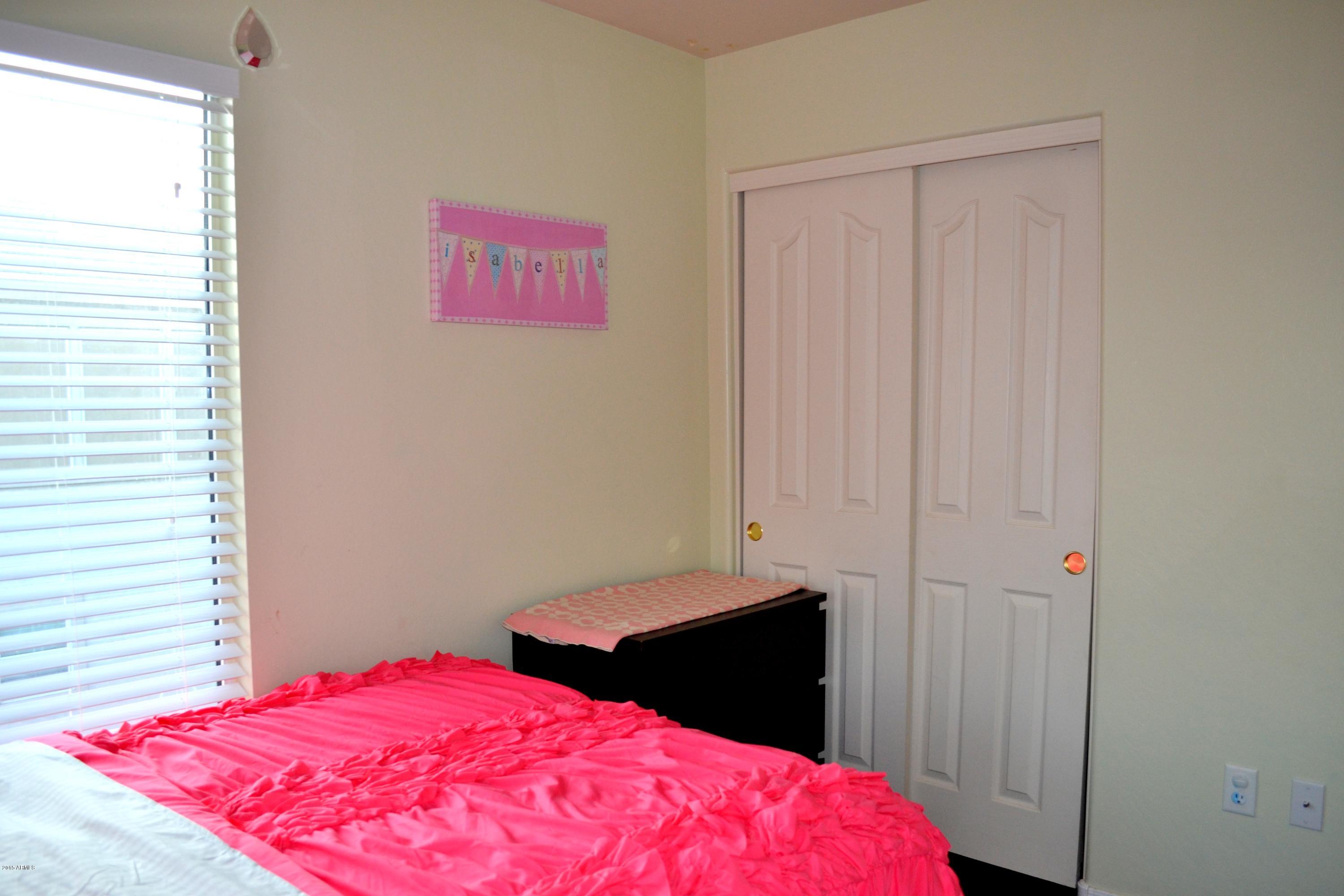 3906 West Carter Road Phoenix, AZ 85041 - Photo 29 of 32 a bedroom with a bed and a closet