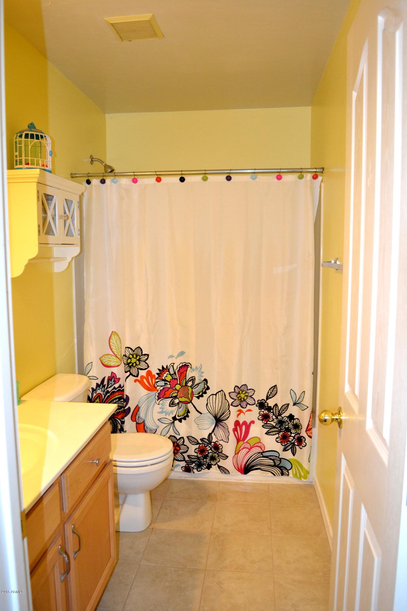 3906 West Carter Road Phoenix, AZ 85041 - Photo 30 of 32 a view of a bathroom with a tub and sink
