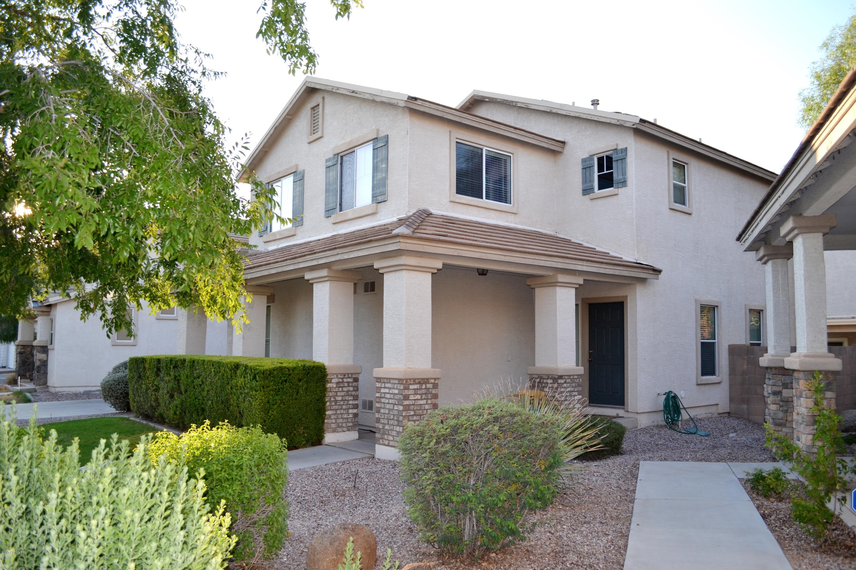 3906 West Carter Road Phoenix, AZ 85041 - Photo 3 of 32 a front view of a house with garden
