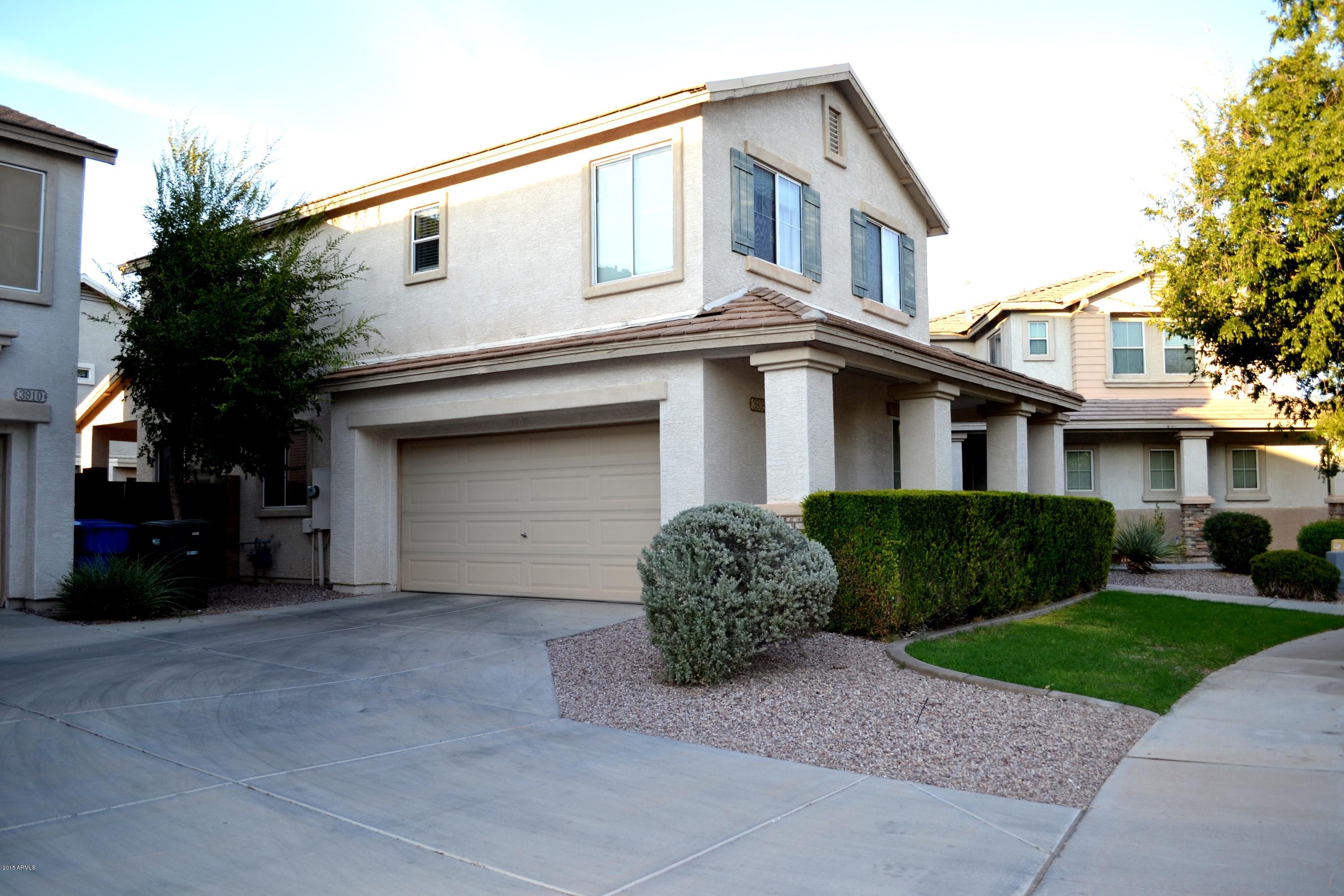 3906 West Carter Road Phoenix, AZ 85041 - Photo 4 of 32 a front view of a house with a yard and garage