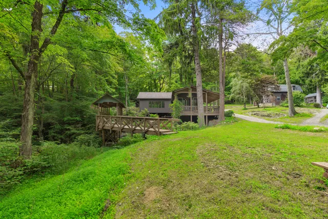 a view of a house with backyard and sitting area