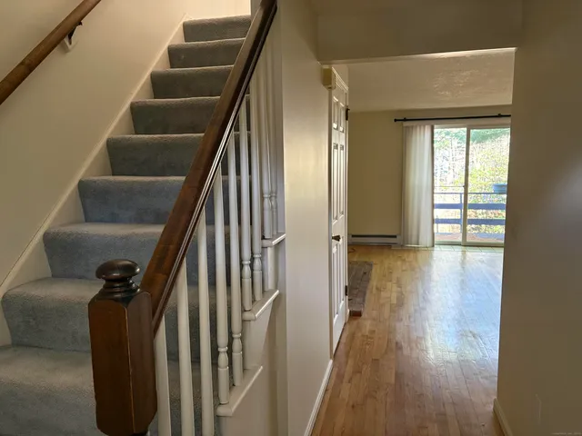 a view of entryway and hall with wooden floor