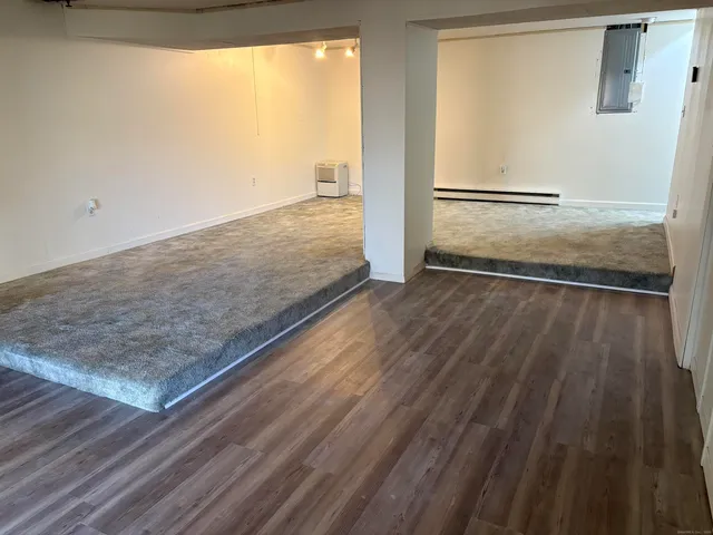 a view of a room with wooden floor