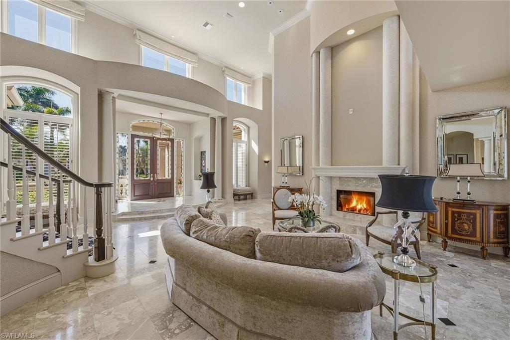 355 Sedgwick Court Naples, FL 34108 - Photo 6 of 48 a living room with furniture and a fireplace