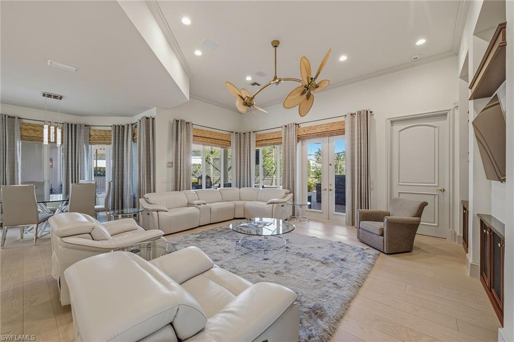 355 Sedgwick Court Naples, FL 34108 - Photo 9 of 48 a living room with furniture and a chandelier