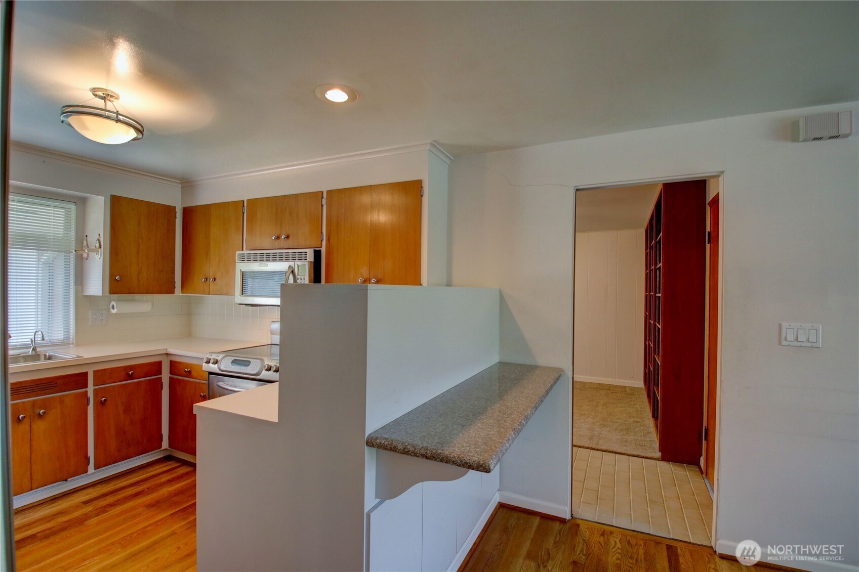 5121 West Highland Road Everett, WA 98203 - Photo 15 of 36 a kitchen with stainless steel appliances granite countertop a refrigerator and a stove top oven