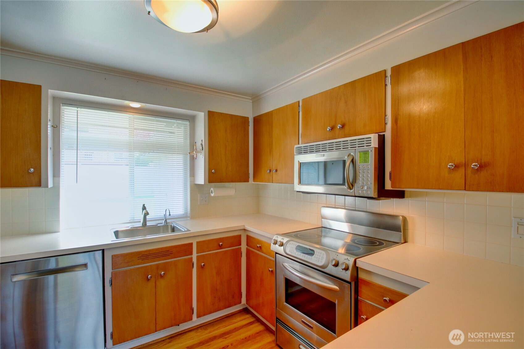 5121 West Highland Road Everett, WA 98203 - Photo 16 of 36 a kitchen with stainless steel appliances granite countertop a sink stove and cabinets