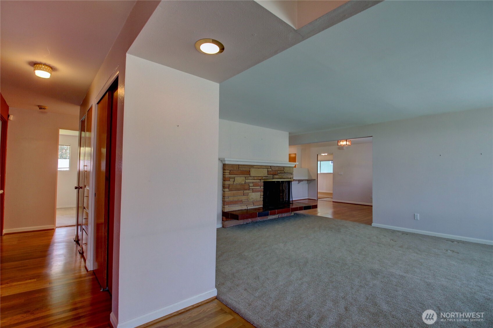 5121 West Highland Road Everett, WA 98203 - Photo 26 of 36 a view of an empty room with wooden floor and a fireplace