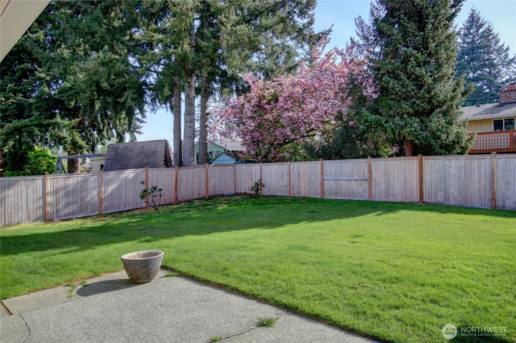 5121 West Highland Road Everett, WA 98203 - Photo 28 of 36 a view of a backyard with potted plants and wooden fence