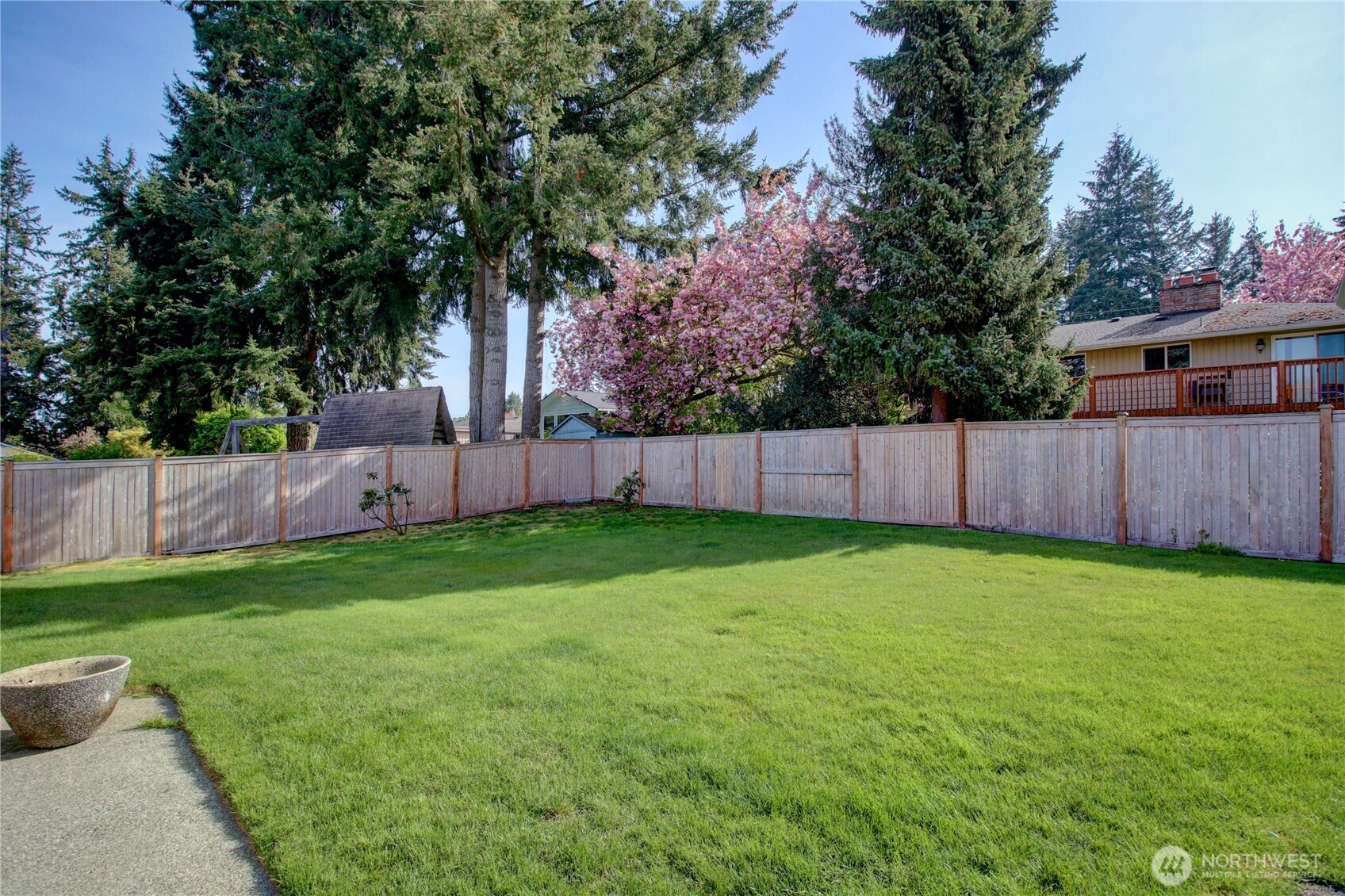 5121 West Highland Road Everett, WA 98203 - Photo 32 of 36 a view of a backyard with large tree and wooden fence