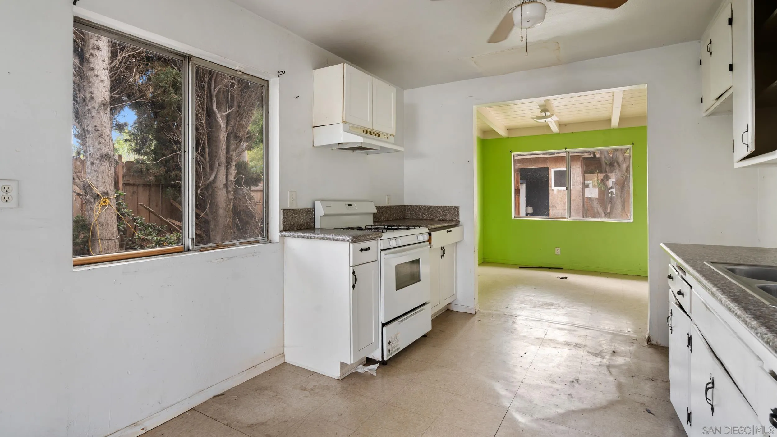 2839 Emerald Drive Oceanside, CA 92056 - Photo 5 of 32 a kitchen with a stove a sink and a window