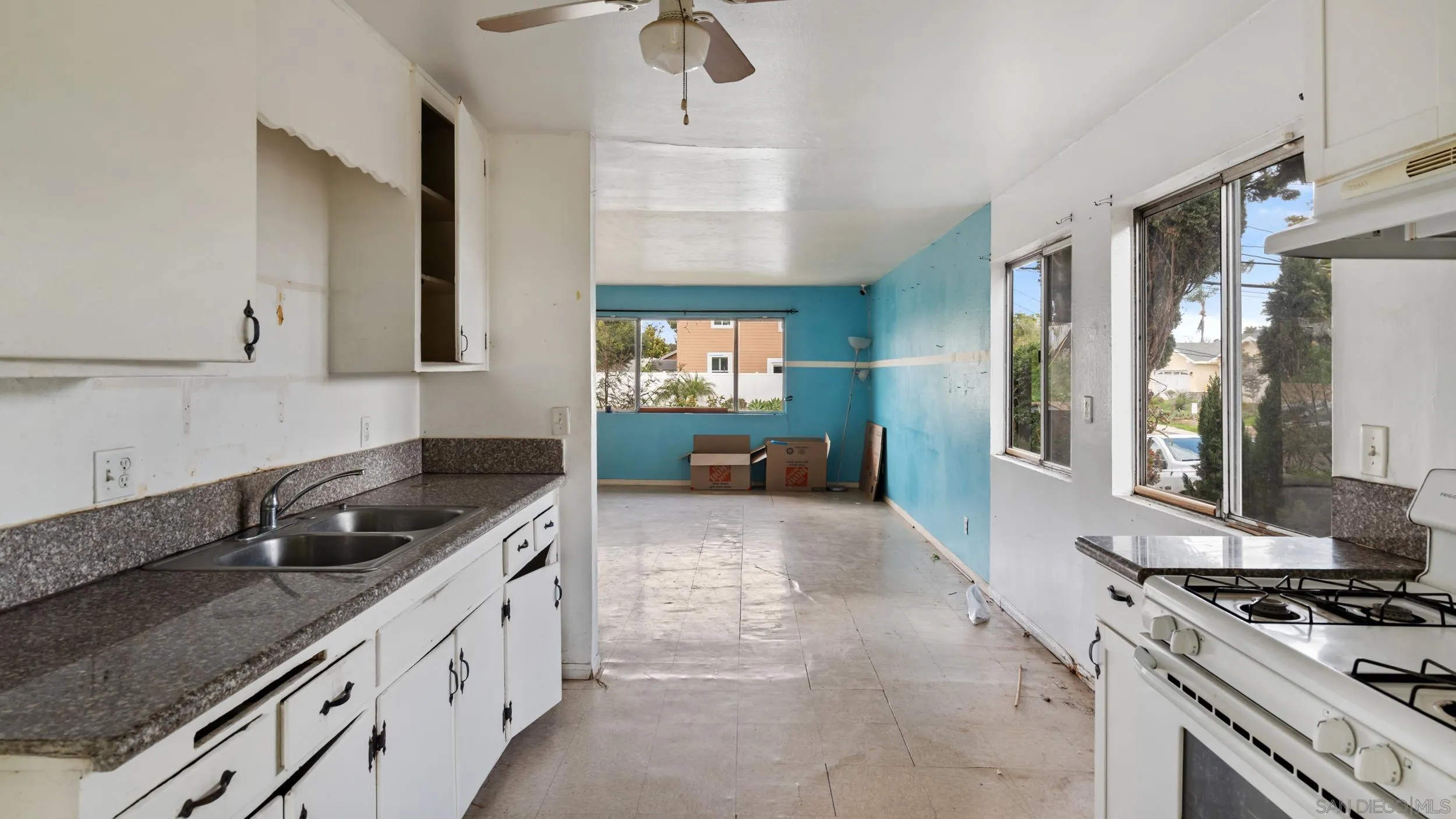 2839 Emerald Drive Oceanside, CA 92056 - Photo 10 of 32 a kitchen with granite countertop a sink stove and cabinets