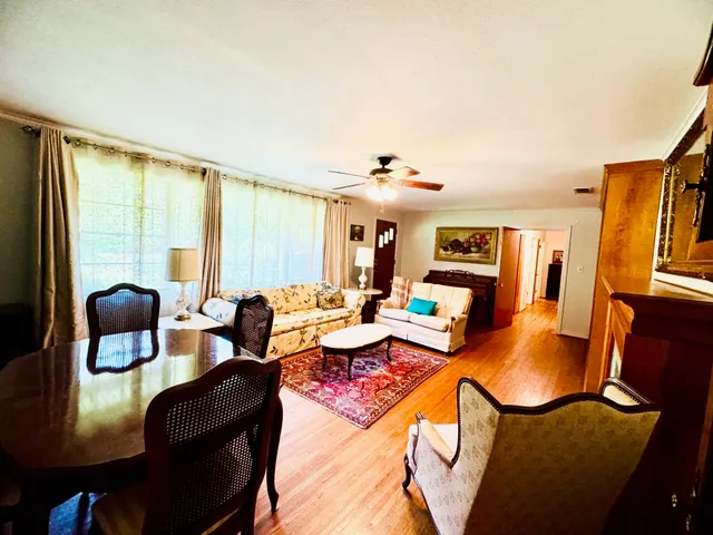 a living room with furniture a fireplace and a large window