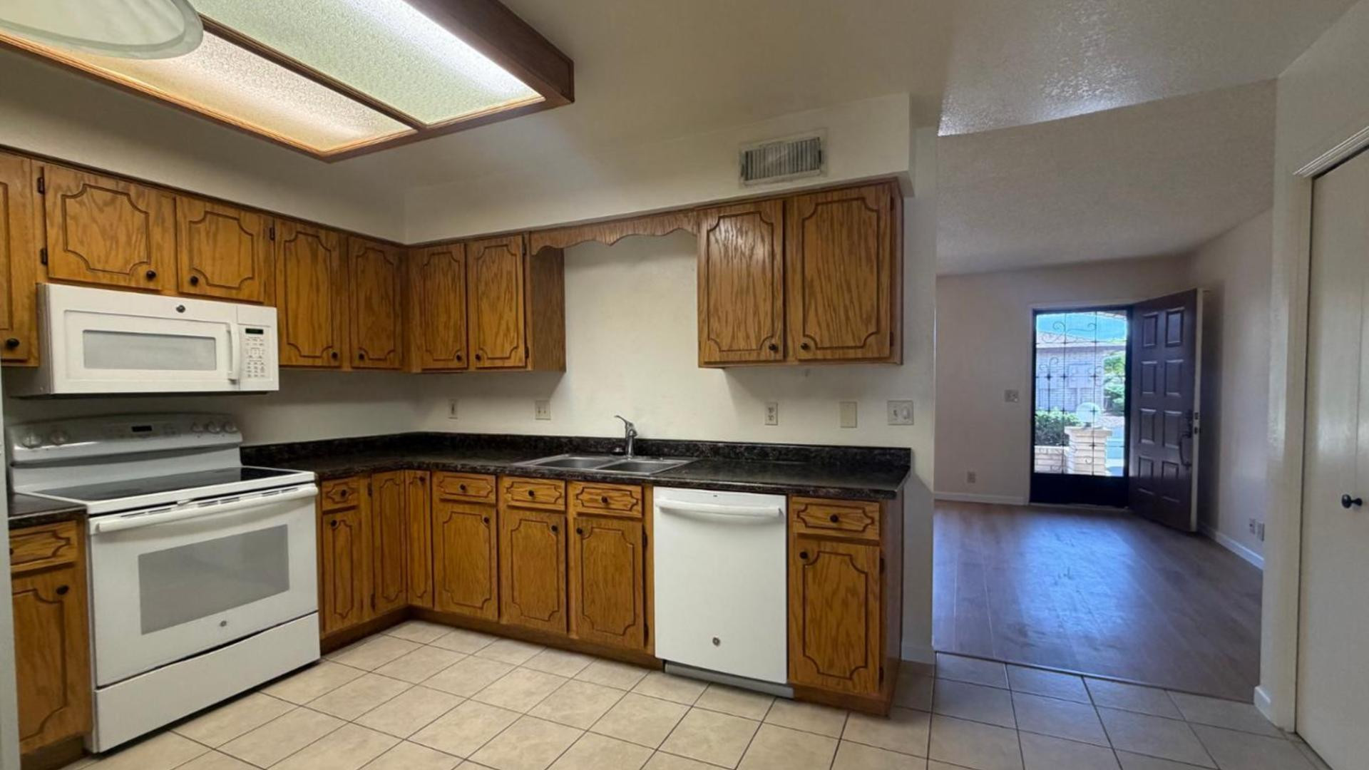 520 South Greenfield Road, Unit 41 Mesa, AZ 85206 - Photo 2 of 24 a kitchen with a stove sink and cabinets