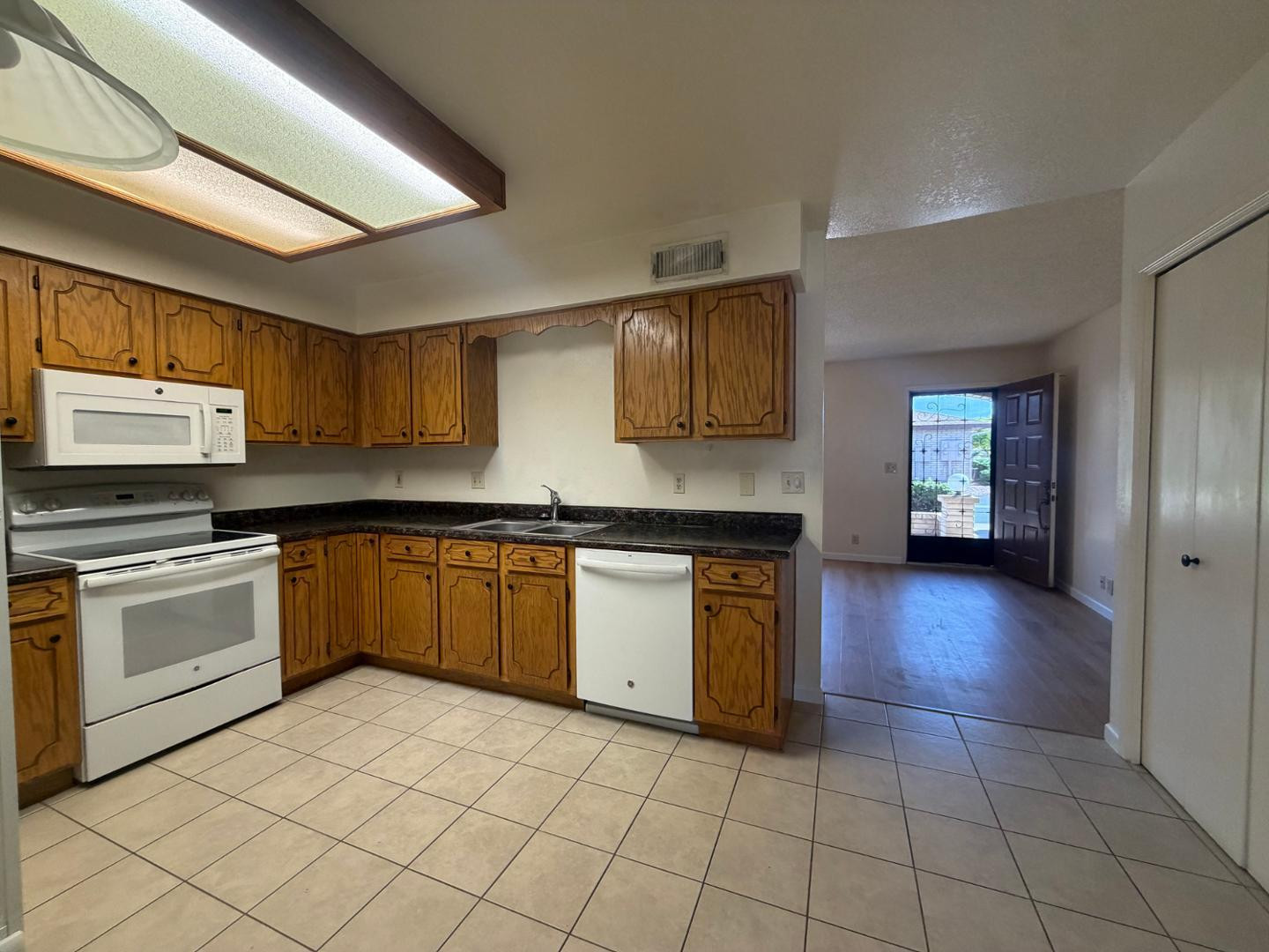 520 South Greenfield Road, Unit 41 Mesa, AZ 85206 - Photo 6 of 24 a kitchen with granite countertop a stove a sink and a microwave